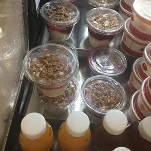 a variety of yogurt and fruit in plastic containers