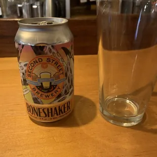 a glass and a can of beer