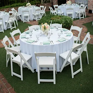Resin Folding Wedding Chairs white and round tables set up