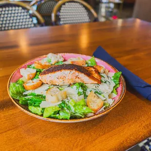 Caesar Augustus (V): Romaine + Croutons + Parmesan Romano Cheese + Caesar Dressing

Add Chicken $5 or Salmon $7

(Blackened or Grilled)