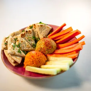 Hummus Plate (V): Roasted Red Pepper Hummus + Jalapeño Cilantro Hummus + Warm Naan + Carrots + Cucumber