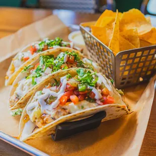 The Benny Blanco: Grilled Marinated Chicken + Shredded Cheese + Roasted Tomatillo Salsa + Pico de Gallo + Queso + Crema + Soft Flour