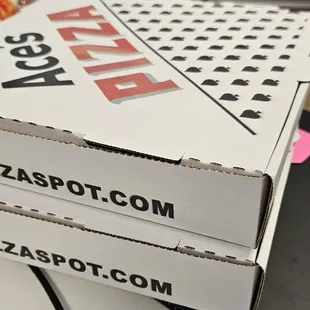 pizza boxes stacked on top of each other