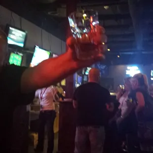 a man holding a glass of beer