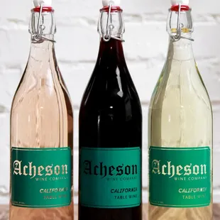 3 Acheson bottles with rose, red and white wine