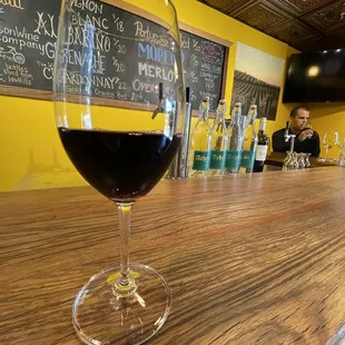 a glass of wine on a bar