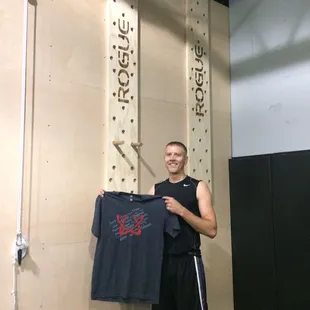 T-shirt warmed for his hard work and climbing the pegboard