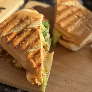a grilled sandwich on a cutting board