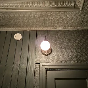 a light on the ceiling in a dark room