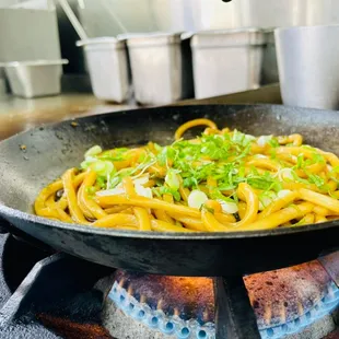 a frying pan with noodles