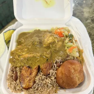 Curry chicken, vegetables, rice and beans, and festival bread.