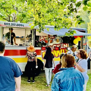 Customers ordering at Acme Chicken Bowls Food Truck