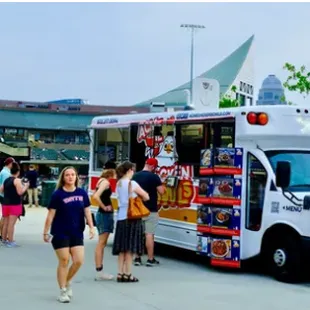 a food truck parked in front of a crowd