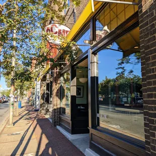 Outside. Storefront. Free parking located in gravel and paved lots behind the building.