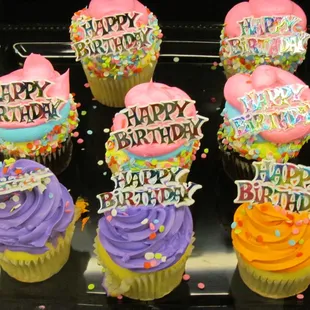 a display of cupcakes with happy birthday written on them