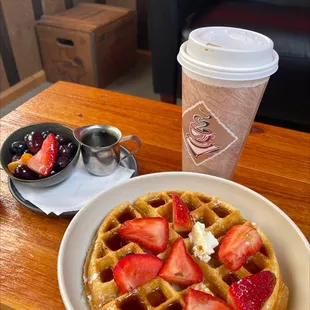 a plate of waffles and a cup of coffee