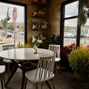 a table and chairs in front of a window