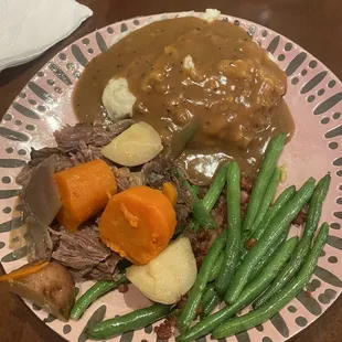 Pot roast with mashed potatoes and green beans with bacon.