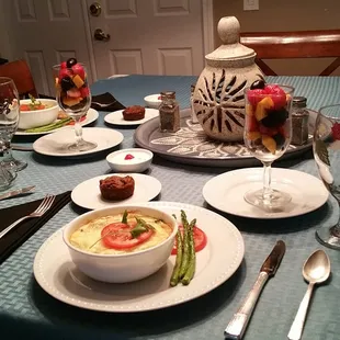 Swiss Spinach Quiche, asparagus spears, chicken apple or pork sausage, fruit, homemade whipped cream &amp; sweet potato muffin.