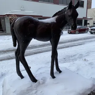 a statue of a horse in the snow