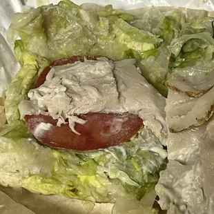 a chicken sandwich with lettuce and tomato
