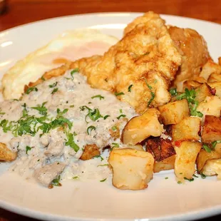 The Brunch Chick was made with buttermilk-battered fried chicken, two eggs, sausage gravy, honey cayenne sauce, biscuit, and potatoes.