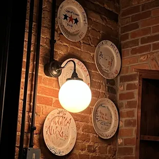 a brick wall with plates on it