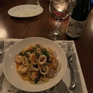Seafood over fettuccine and choice of wine