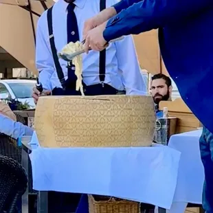 Freshly made pasta rolled table-side in authentic Italian cheese wheel