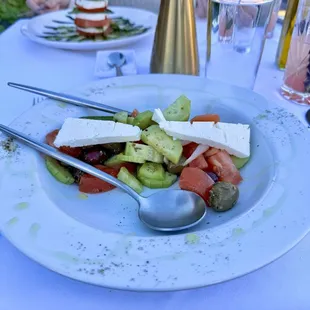 A fresh and crisp Greek Salad tastefully drizzled with flavorful olive oil