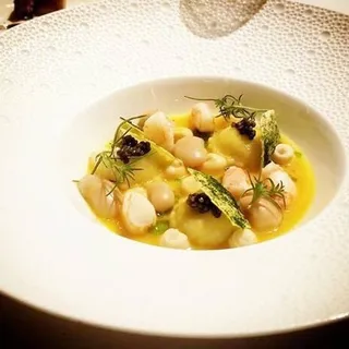 Grilled octopus and corona beans in a spicy tomato stew with squid ink and tuna heart