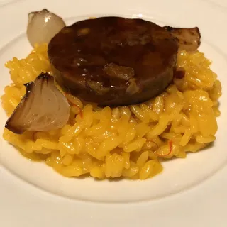 Saffron risotto, braised veal, golden raisins, and pinenuts