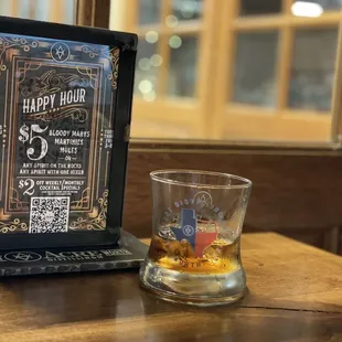 a glass of whiskey on a table