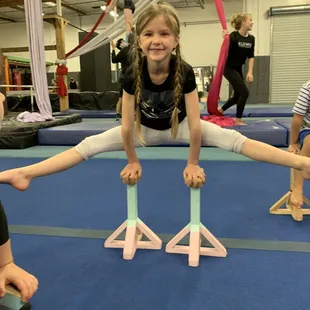 Holding a straddle on blocks.