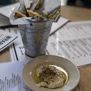 a plate of food and a bucket of crackers