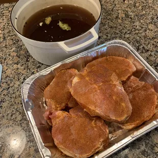 a pan of meats and a pot of soup