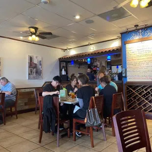 people sitting at tables in a restaurant