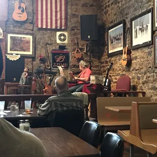 a man playing guitar in a restaurant