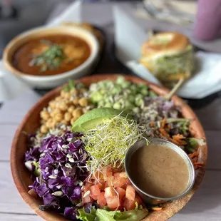a bowl of salad with a side of soup