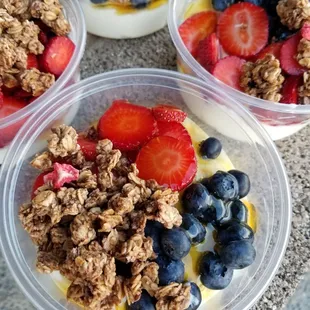 three bowls of fruit and yogurt