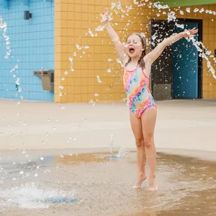 Young girl walking through water feature at Ad Astra Pool. Photo by Jeanie Webster.