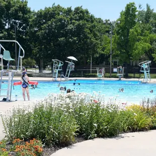 Ad Astra Pool in the distance with lifeguard watching swimmers. Photo by Wendy Delzeit.