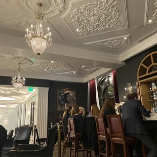 a group of people sitting at a bar