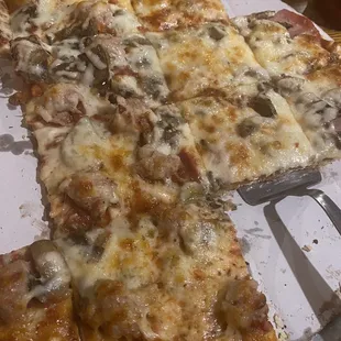 Large pizza with mushrooms and half Canadian bacon and half sausage
