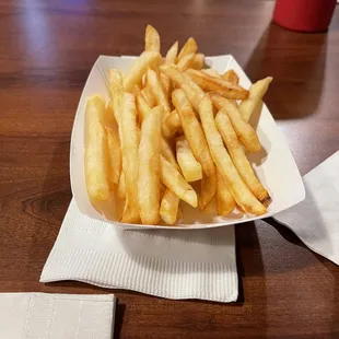 a plate of french fries on a table