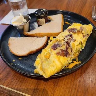 an omelet, bread, and butter on a plate