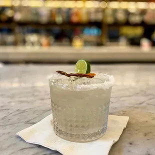 a margarita with a slice of lime on the rim