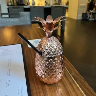 a pineapple cocktail in a copper glass