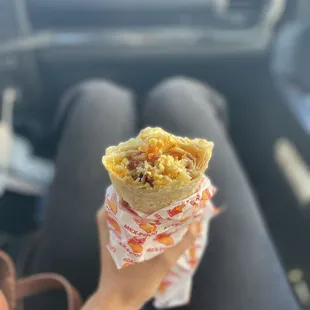 a person holding a burrito
