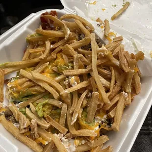 a white styrofoam container filled with french fries